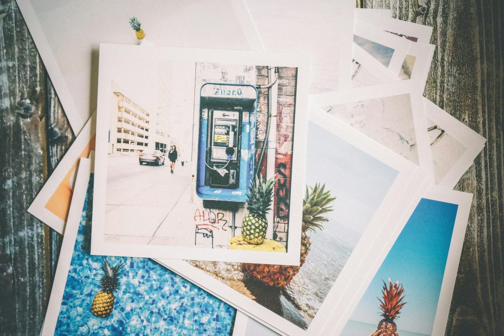 Vintage-style travel photo prints with a nostalgic feel on a wooden surface.