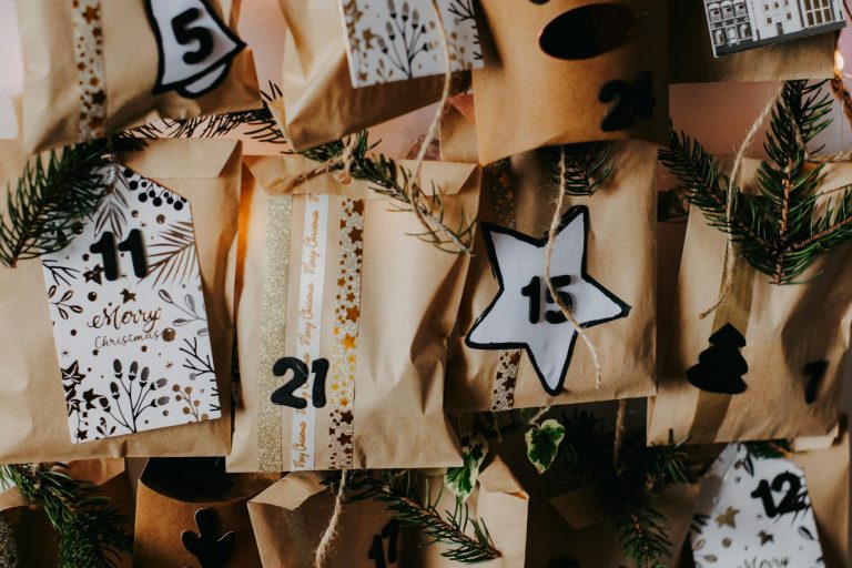 Festive DIY advent calendar with numbered paper bags for Christmas countdown.