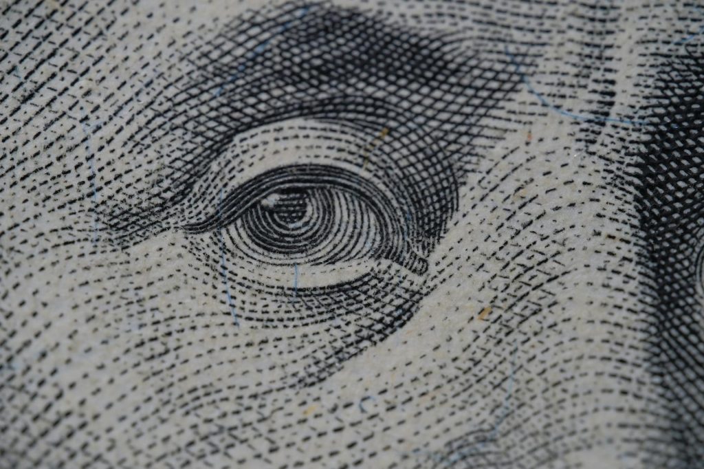 Detailed close-up of an illustration from a dollar bill, focusing on intricate line work.