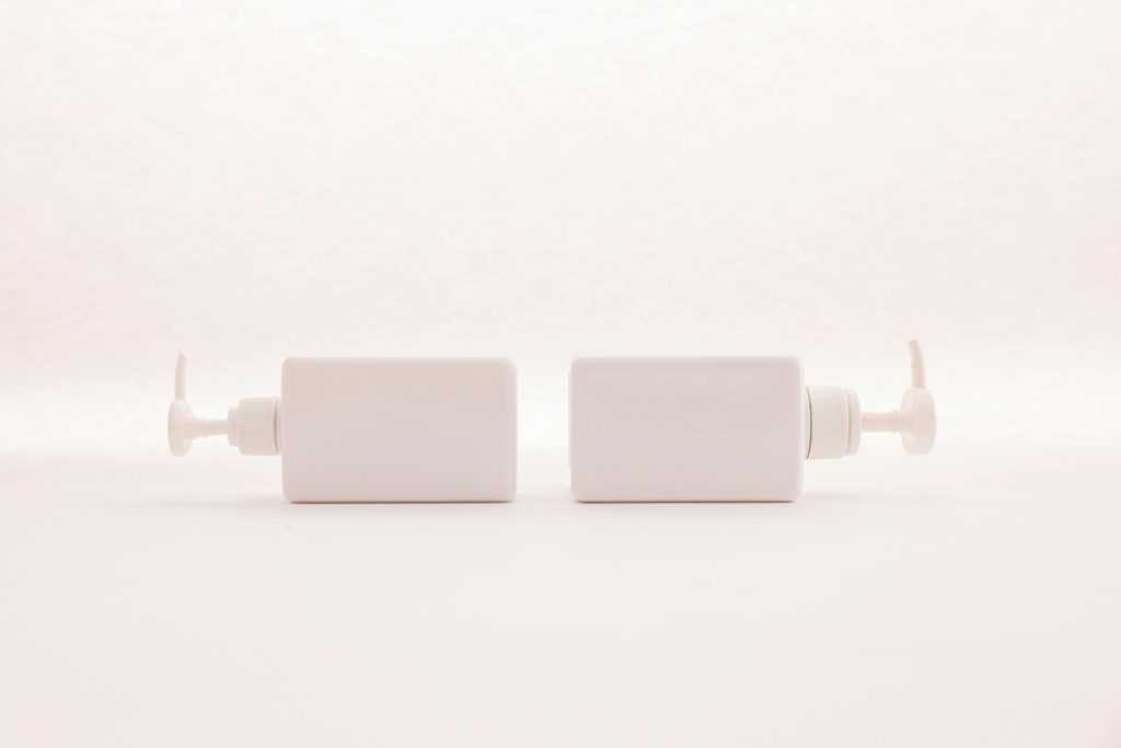 Simple and elegant white pump bottles on a clean white background, perfect for beauty product mockups.