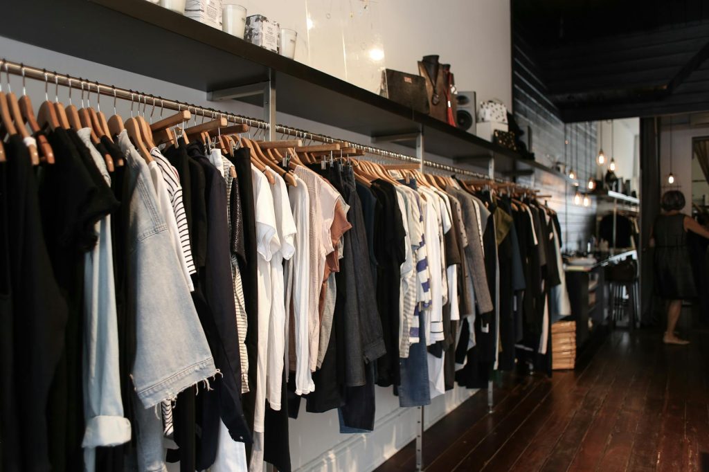 Explore trendy fashion displayed in an elegant boutique setting, showcasing diverse clothing styles.
