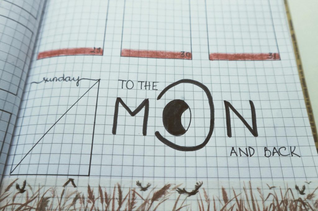Notebook page featuring 'To the Moon and Back' with creative grid design.