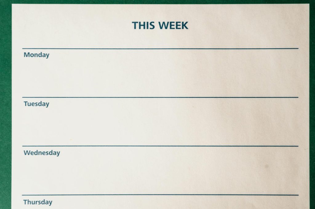 Minimalist blank weekly planner with days for scheduling and organizing tasks.