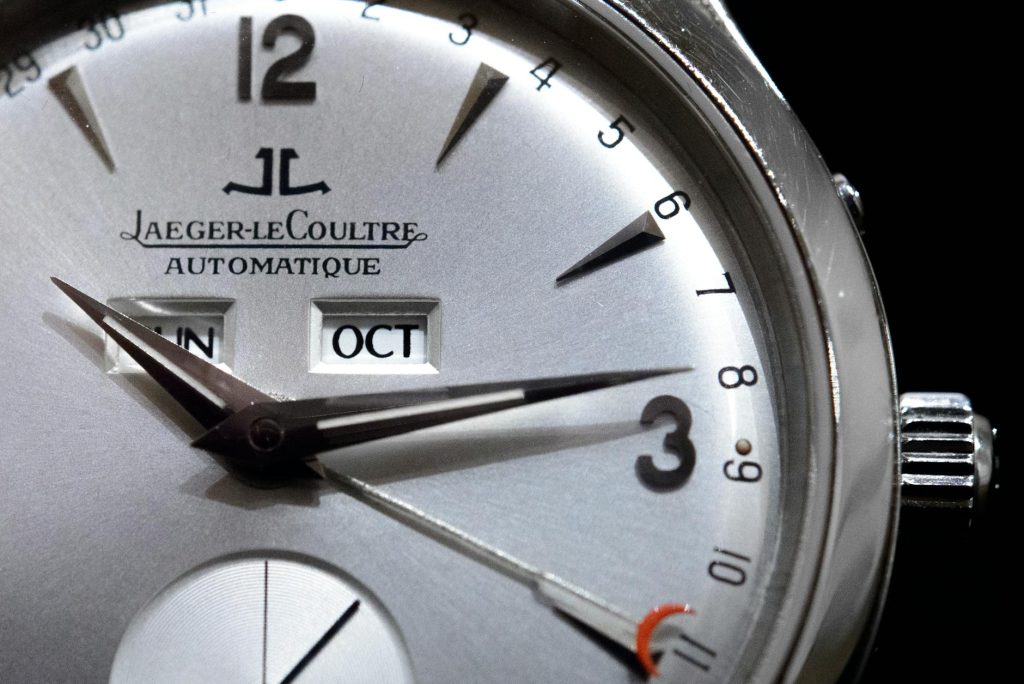 Detailed close-up of a Jaeger-LeCoultre wristwatch, showcasing its elegant dial and features.