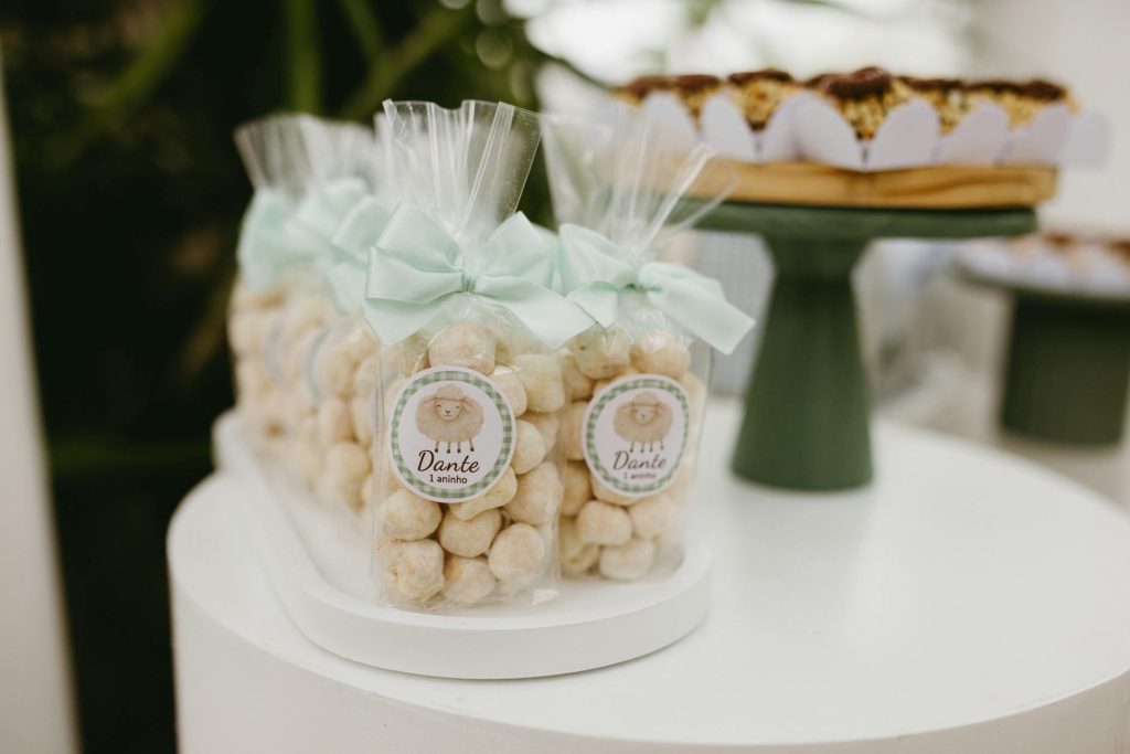 Adorable first birthday party favors in soft lighting, featuring bow-wrapped treats.