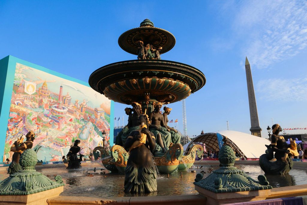 Vibrant view of iconic Place de la Concorde fountain in Paris with obelisk and cityscape