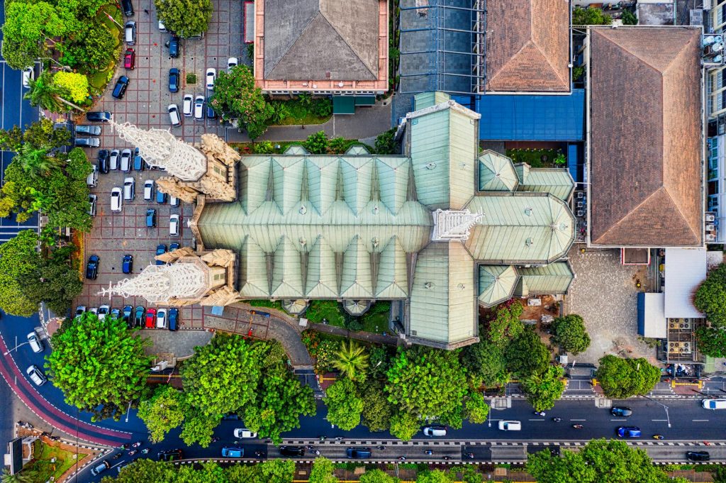 Stunning aerial view of Jakarta Cathedral surrounded by lush greenery and cityscape.