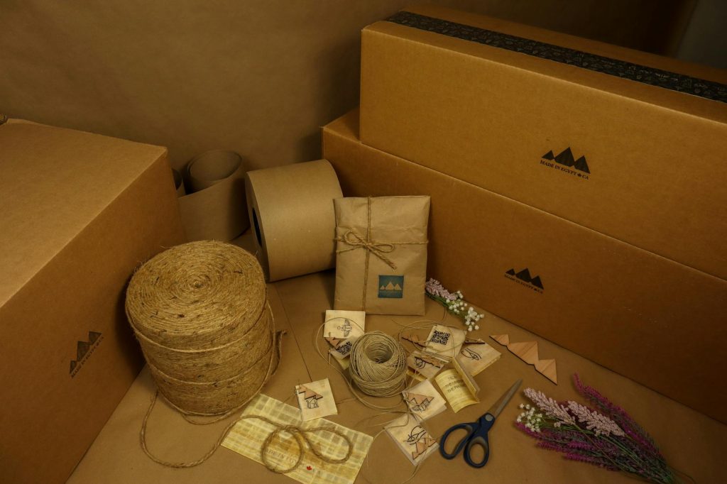 Explore a variety of eco-friendly packaging materials including boxes, kraft paper, and twine for sustainable shipping solutions.