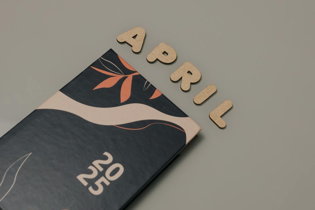 Artistic 2025 wall calendar with April text; minimalist and modern aesthetic.