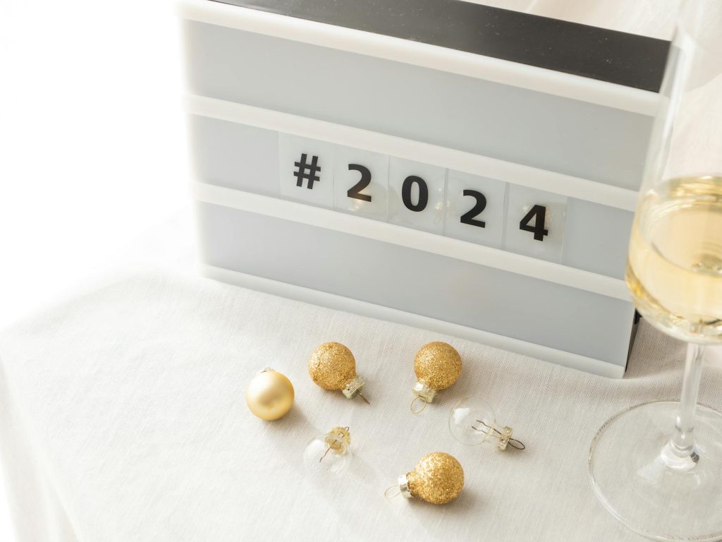 Festive New Year 2024 setup with champagne and golden decor. Perfect for celebrations and parties.