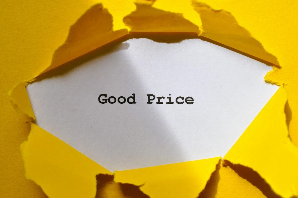 Yellow paper torn to reveal 'Good Price'. Perfect for sales and marketing concepts.