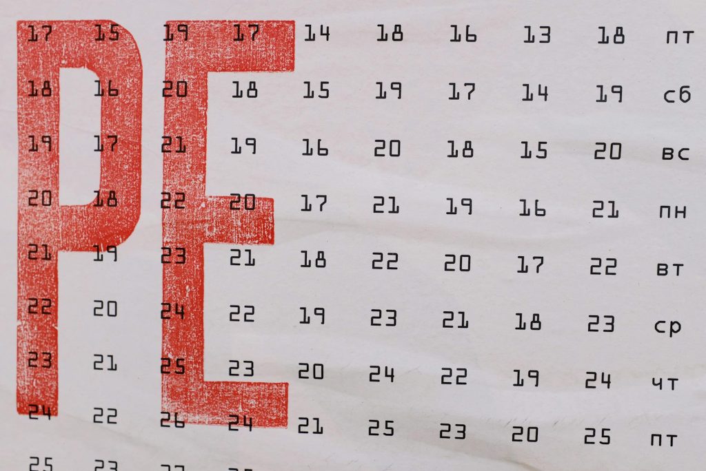 Weekdays in Russian language and dates shown on page of calendar with two drawn big red letters
