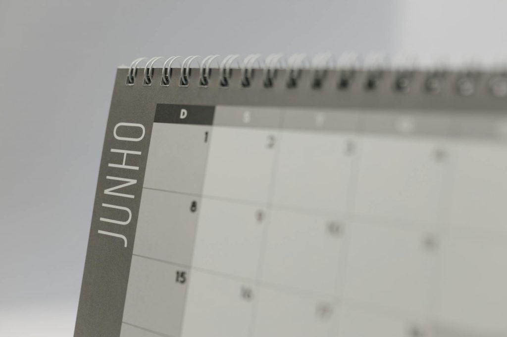 A detailed shot of a June calendar page with spiral binding, featuring Portuguese text.