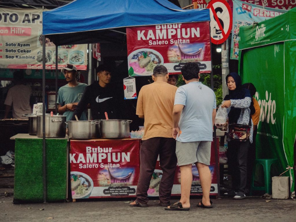 Lively street food scene at a Jakarta bazaar with diverse local cuisine.
