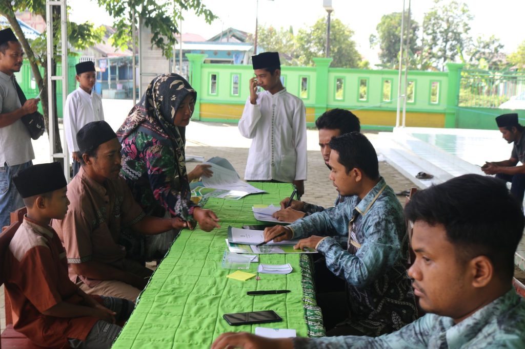 People gathered outdoors for voting registration, engaging in community participation.