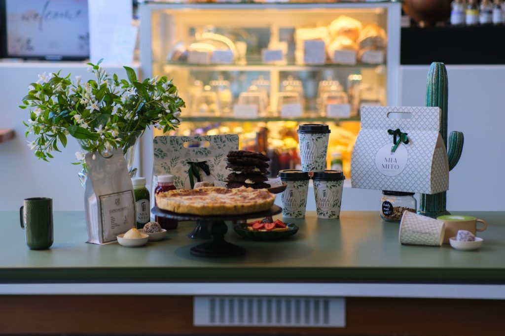 A beautifully arranged cafe table in Ankara featuring pastries, coffee cups, and decorative plants.