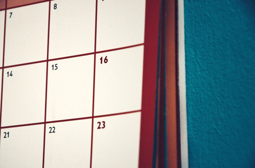 A minimalist calendar hanging on a colorful wall, perfect for planning and organization.